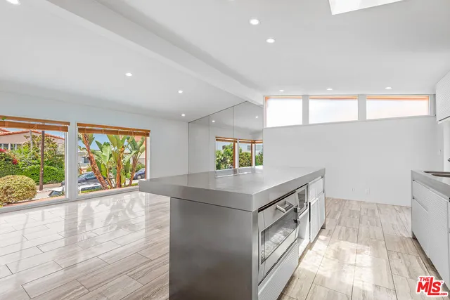 a kitchen with a sink and a stove top oven