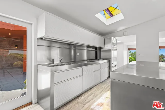 a kitchen with stainless steel appliances granite countertop a refrigerator and a stove