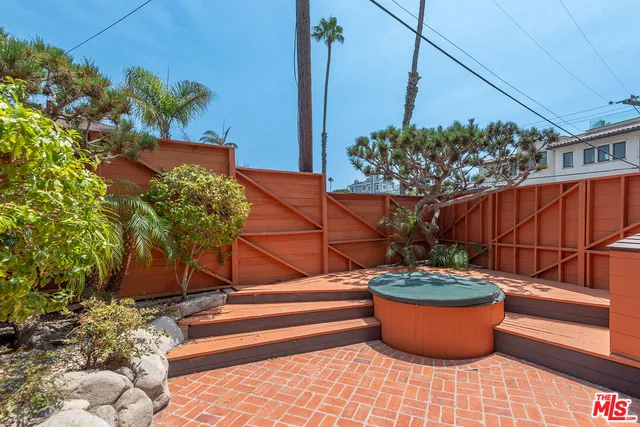 a view of a potted flower in a backyard