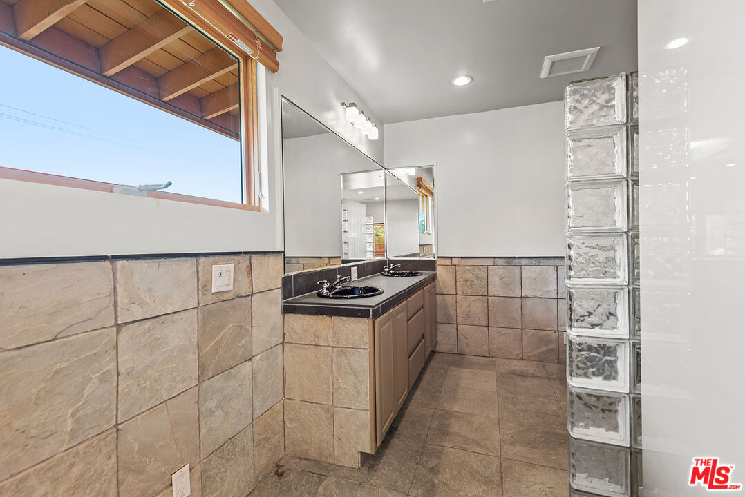 7220 Rindge Avenue Playa del Rey, CA 90293 - Photo 35 of 53 a kitchen with granite countertop a sink and a stove top oven