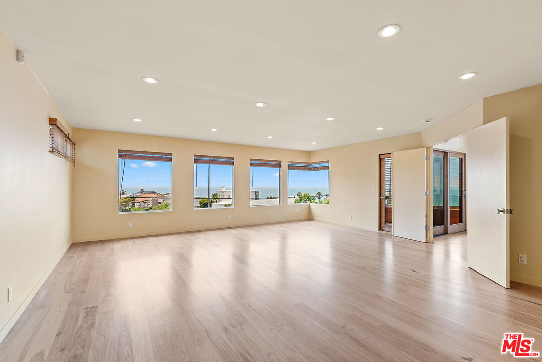 7220 Rindge Avenue Playa del Rey, CA 90293 - Photo 40 of 53 a view of an empty room with wooden floor and a window