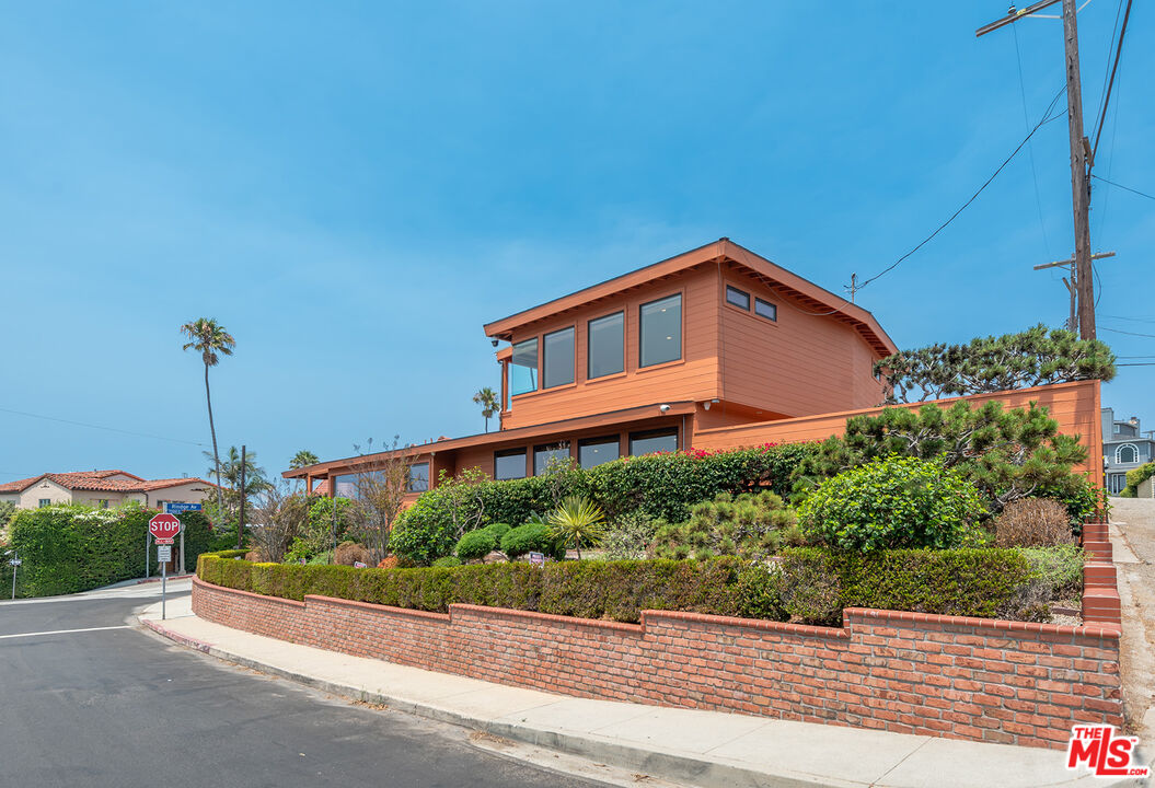 7220 Rindge Avenue Playa del Rey, CA 90293 - Photo 53 of 53 a front view of a house with a yard and potted plants