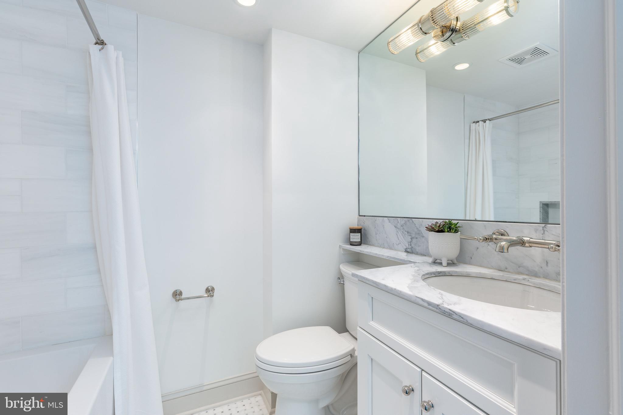 632 Spruce Street Philadelphia, PA 19106 - Photo 72 of 88 a bathroom with a granite countertop sink a toilet and a mirror