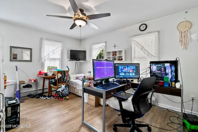 a view of a workspace with furniture and a flat screen tv