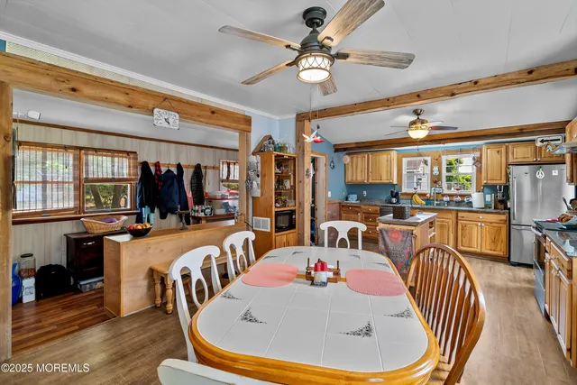 a kitchen with a dining table and chairs