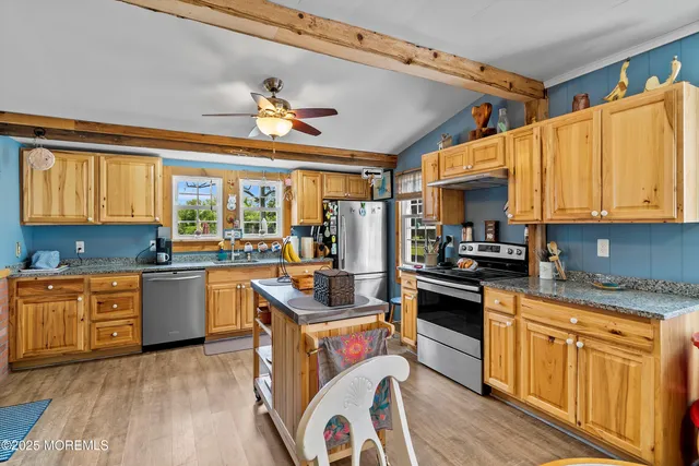 a kitchen with a stove a sink and a refrigerator