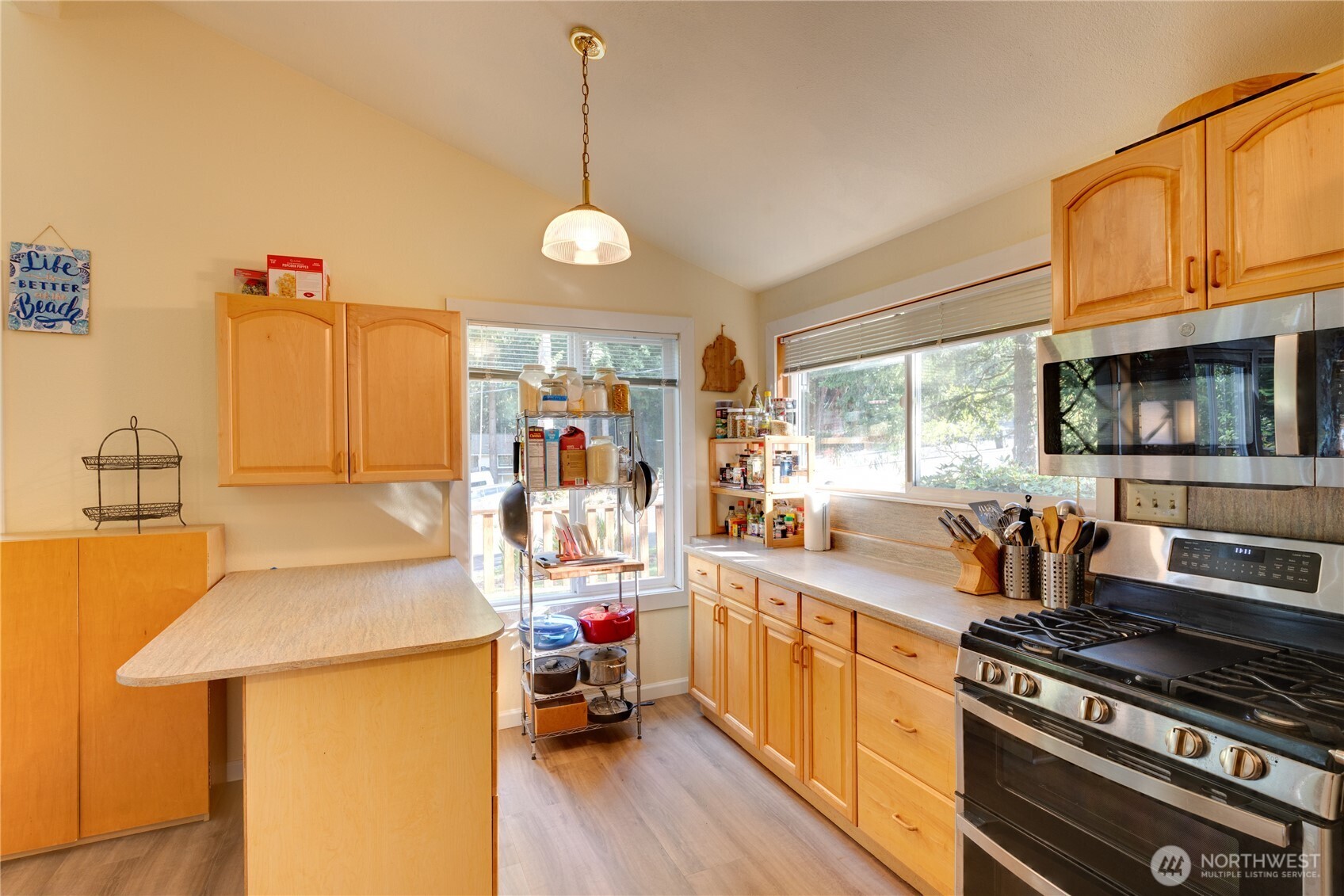 2872 Hi Crest Road Langley, WA 98260 - Photo 15 of 33 a kitchen with a stove a sink and a wooden floor