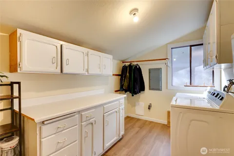 a kitchen with a white cabinets and white appliances