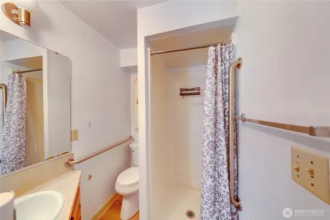a bathroom with a sink toilet and shower