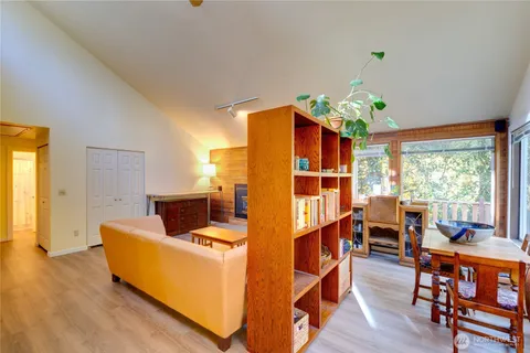 a living room with furniture dining table and wooden floor