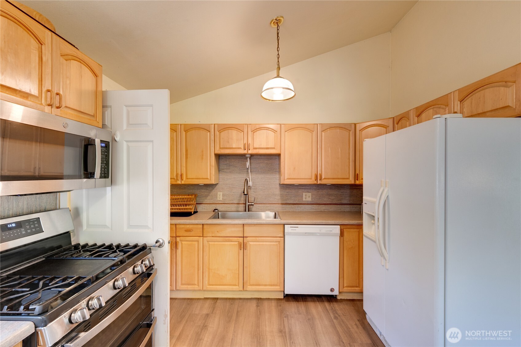 2872 Hi Crest Road Langley, WA 98260 - Photo 10 of 33 a kitchen with a refrigerator and a stove top oven