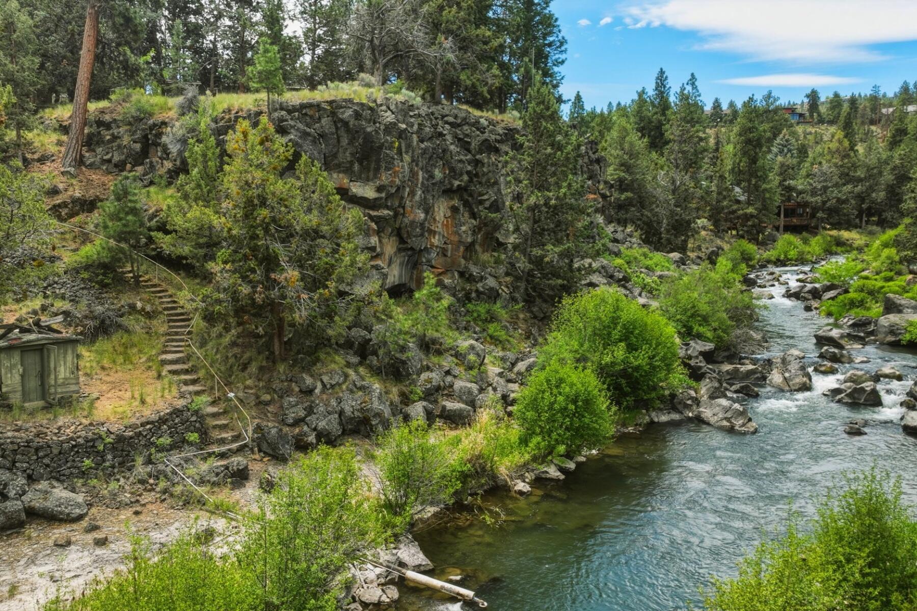 637 Northwest Silver Buckle Road Bend, OR 97703 - Photo 56 of 68 a view of a lake with a building in the background
