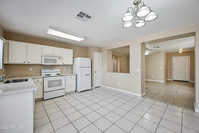 a kitchen with a stove cabinets and a refrigerator
