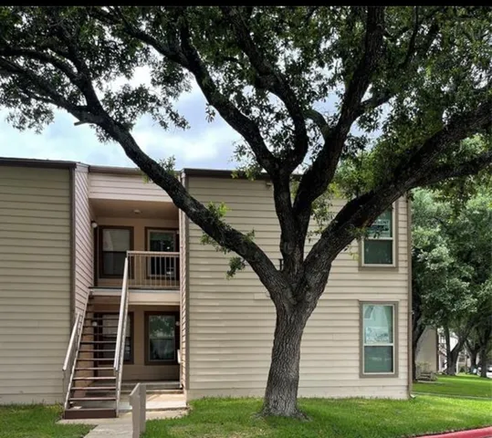 a view of house with a tree