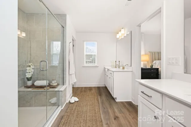 a kitchen with a sink and wooden floor