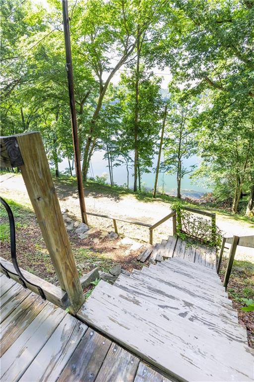 2675 Lakeview Road Confluence, PA 15424 - Photo 20 of 25 a view of a wooden deck with chairs and floor to ceiling window
