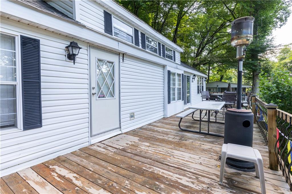 2675 Lakeview Road Confluence, PA 15424 - Photo 4 of 25 a view of a deck with wooden floor and fence with a floor to ceiling window