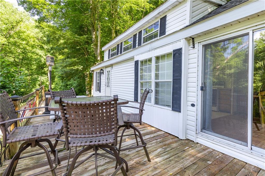 2675 Lakeview Road Confluence, PA 15424 - Photo 6 of 25 a view of a patio with table and chairs and floor to ceiling window