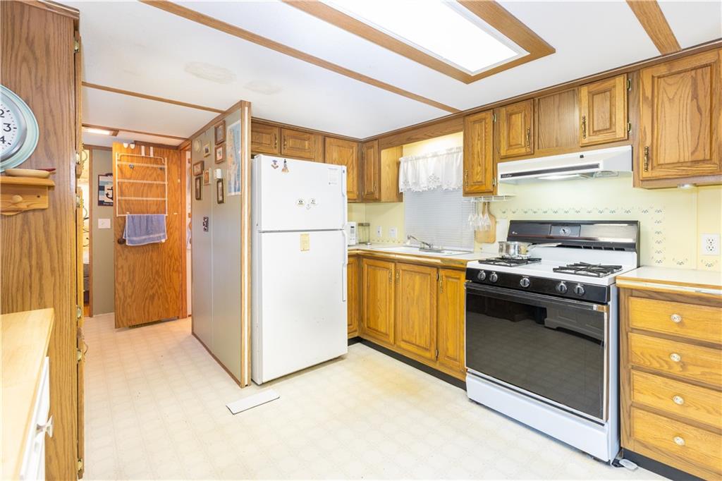 2675 Lakeview Road Confluence, PA 15424 - Photo 9 of 25 a kitchen with a refrigerator a stove top oven and cabinets