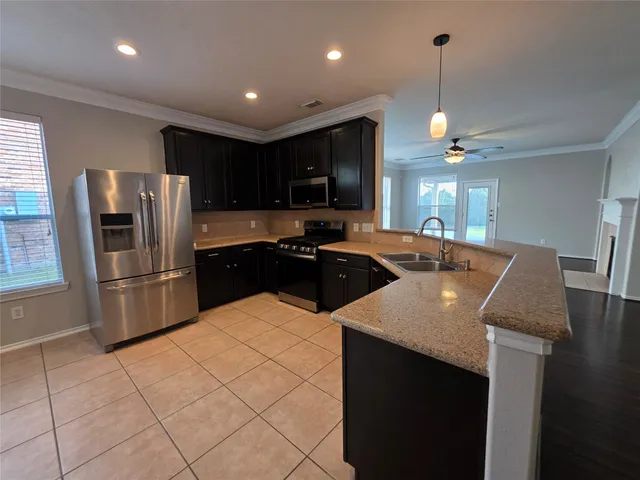 a kitchen with kitchen island a sink appliances and cabinets