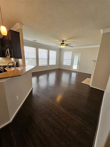 a view of a room with wooden floor and window