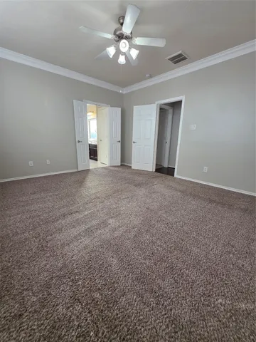 a view of a big room with windows and chandelier fan