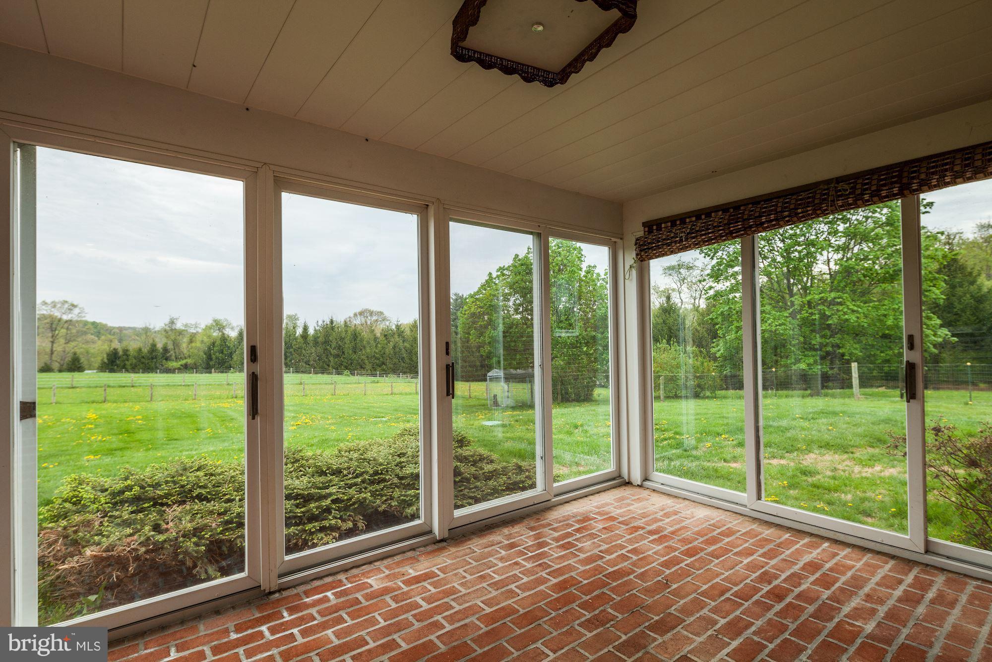 4924 Old Quarter Road Upperco, MD 21155 - Photo 11 of 28 Screened Porch, brick floor, sliding doors.