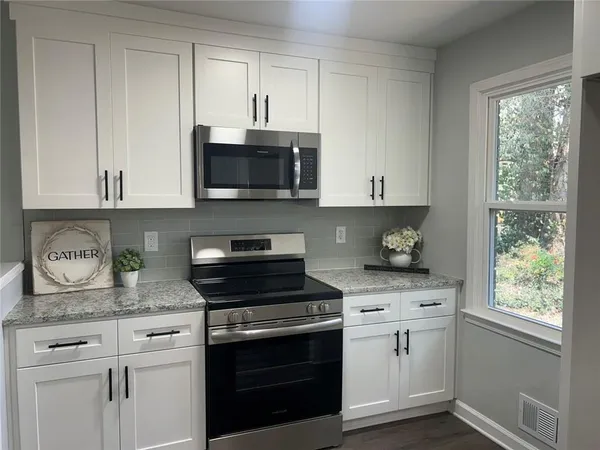 a bathroom with a double vanity sink mirror and shower