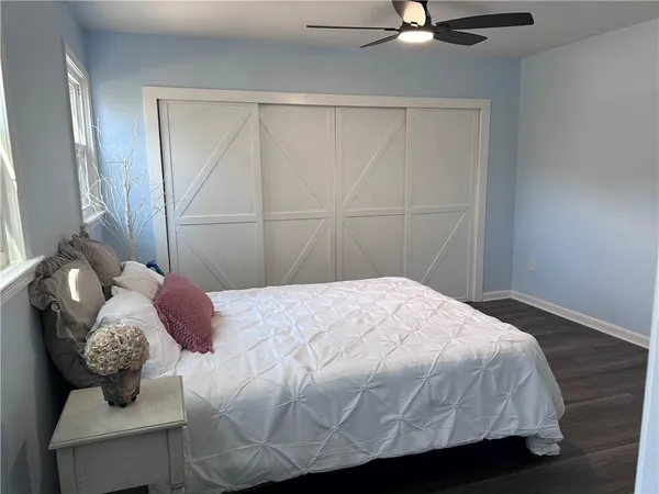 a bathroom with a granite countertop sink a toilet and a mirror