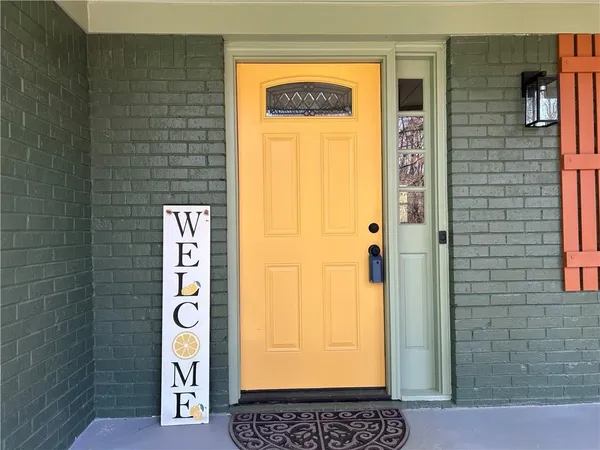 a dining room with wooden floor a chandelier a wooden table and chairs