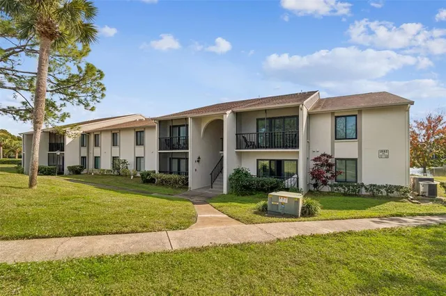 a view of a house with a swimming pool and a yard