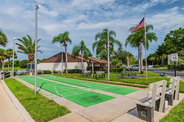 a front view of a house with garden and trees