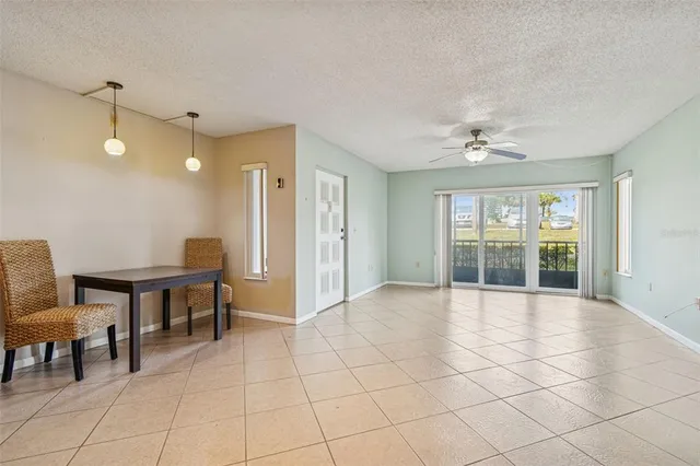 a view of a livingroom with furniture and chandelier fan