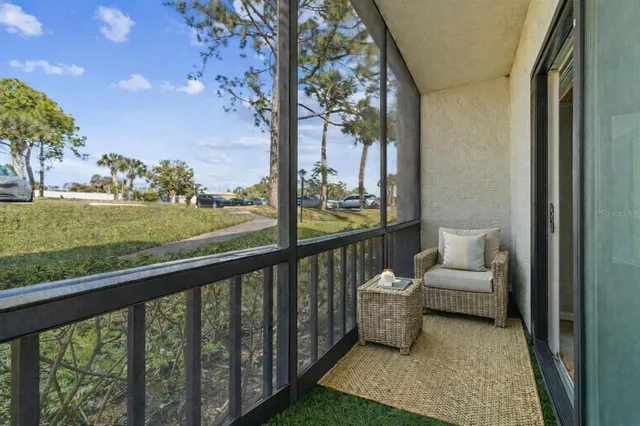 a view of a porch with furniture and garden