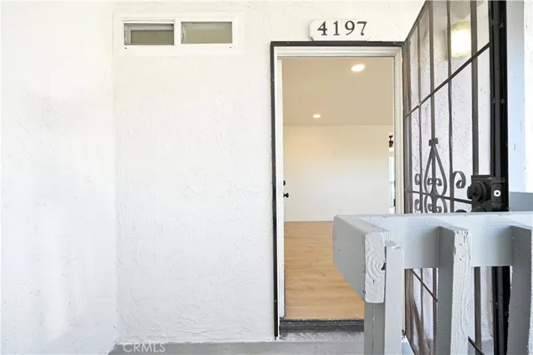 a view of a hallway with furniture and front door