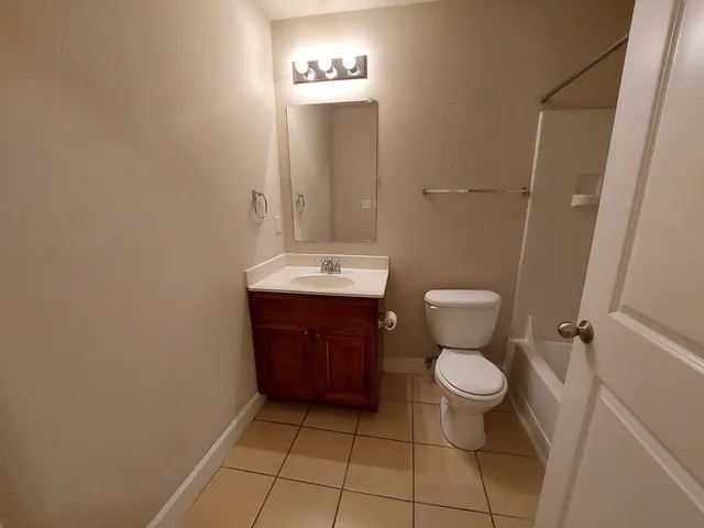 a bathroom with a sink a toilet and mirror