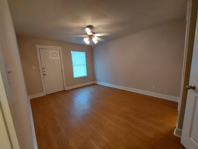 wooden floor in an empty room with a window