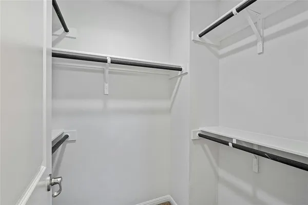 a bathroom with a sink a toilet a mirror and shower