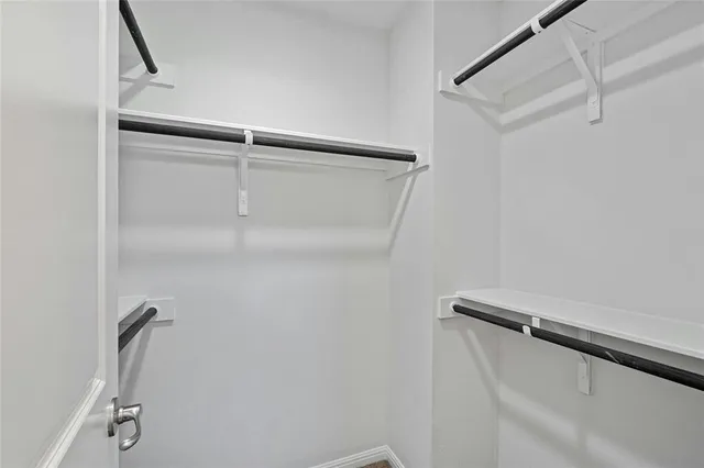 a bathroom with a sink a toilet a mirror and shower