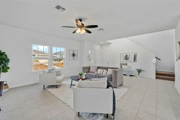 a living room with furniture and a large window