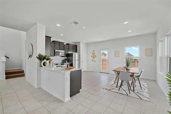 a kitchen with stainless steel appliances a refrigerator stove and sink