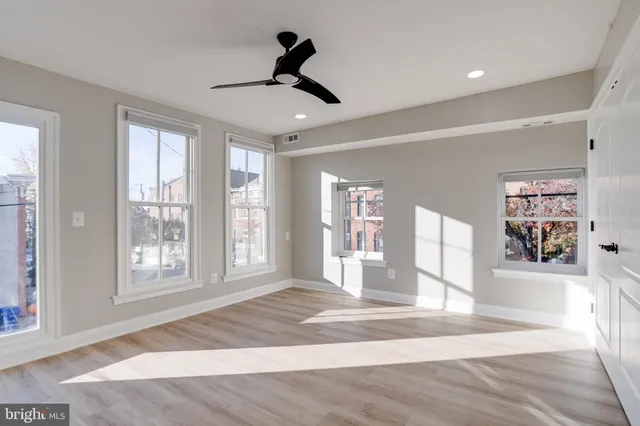 a living room with furniture windows and wooden floor