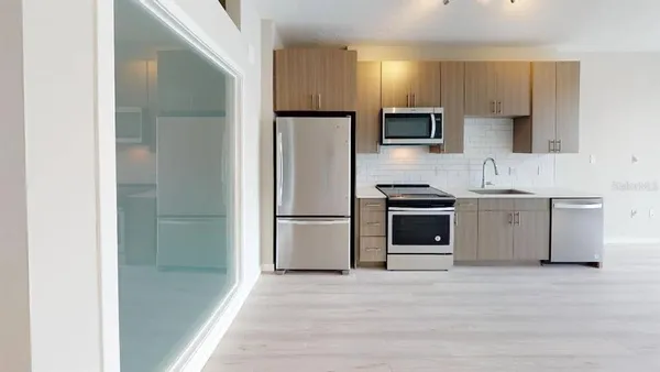 a kitchen with a refrigerator a stove and a sink