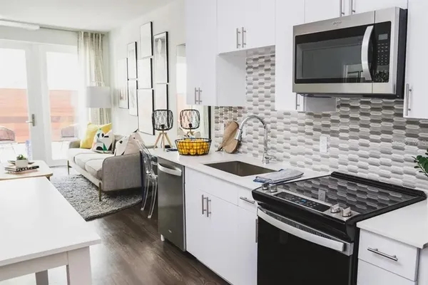 a kitchen with stainless steel appliances a refrigerator stove and microwave