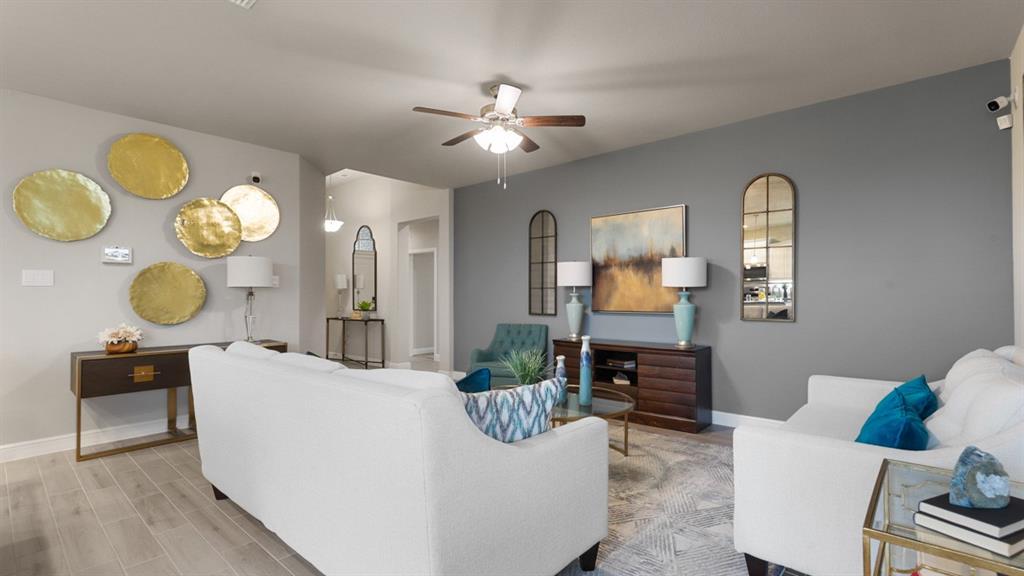 130 Castell Court Rhome, TX 76078 - Photo 15 of 39 a living room with furniture a chandelier and a mirror