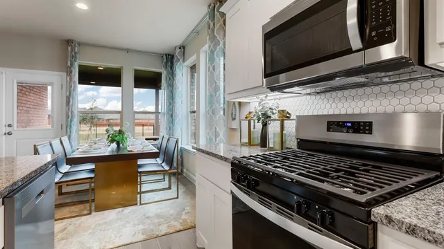 a kitchen with center island a sink appliances and living room view
