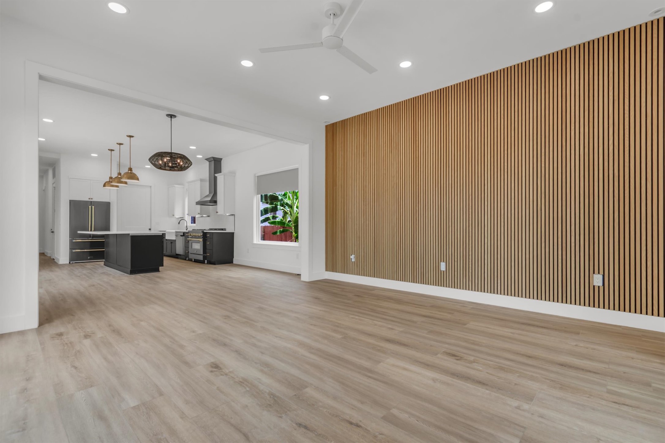 3101 Lyons Road Austin, TX 78702 - Photo 15 of 40 An open-concept living space integrates a stylish kitchen with wood-slat accent wall.