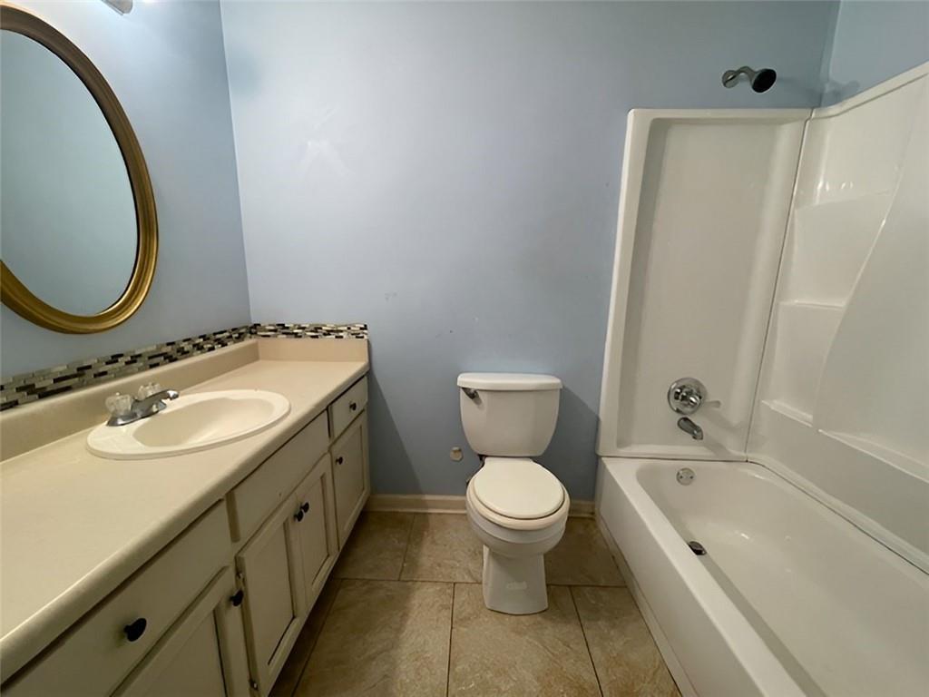 40 Judy Court Stockbridge, GA 30281 - Photo 11 of 14 a bathroom with a granite countertop toilet a sink and a mirror