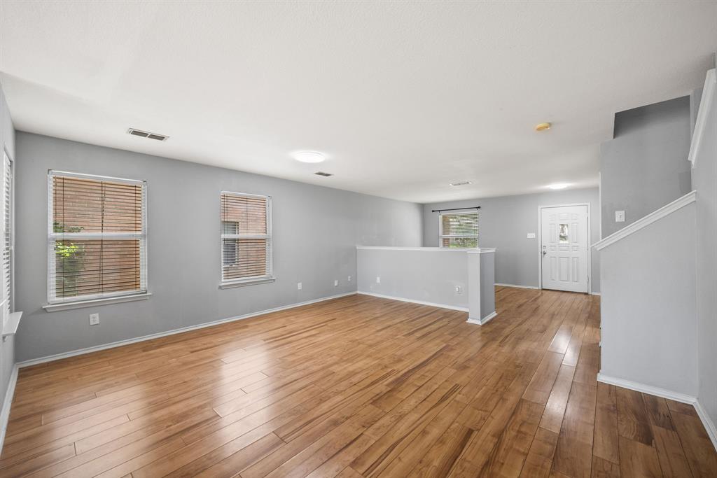 601 Amy Way Euless, TX 76039 - Photo 11 of 40 a view of an empty room with wooden floor and a window