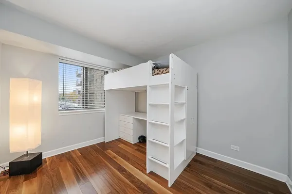 a view of a room with wooden floor and window